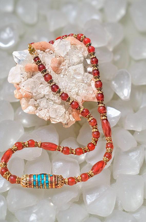 Carnelian necklace with Tibetan focal bead that is trimmed in turquoise.