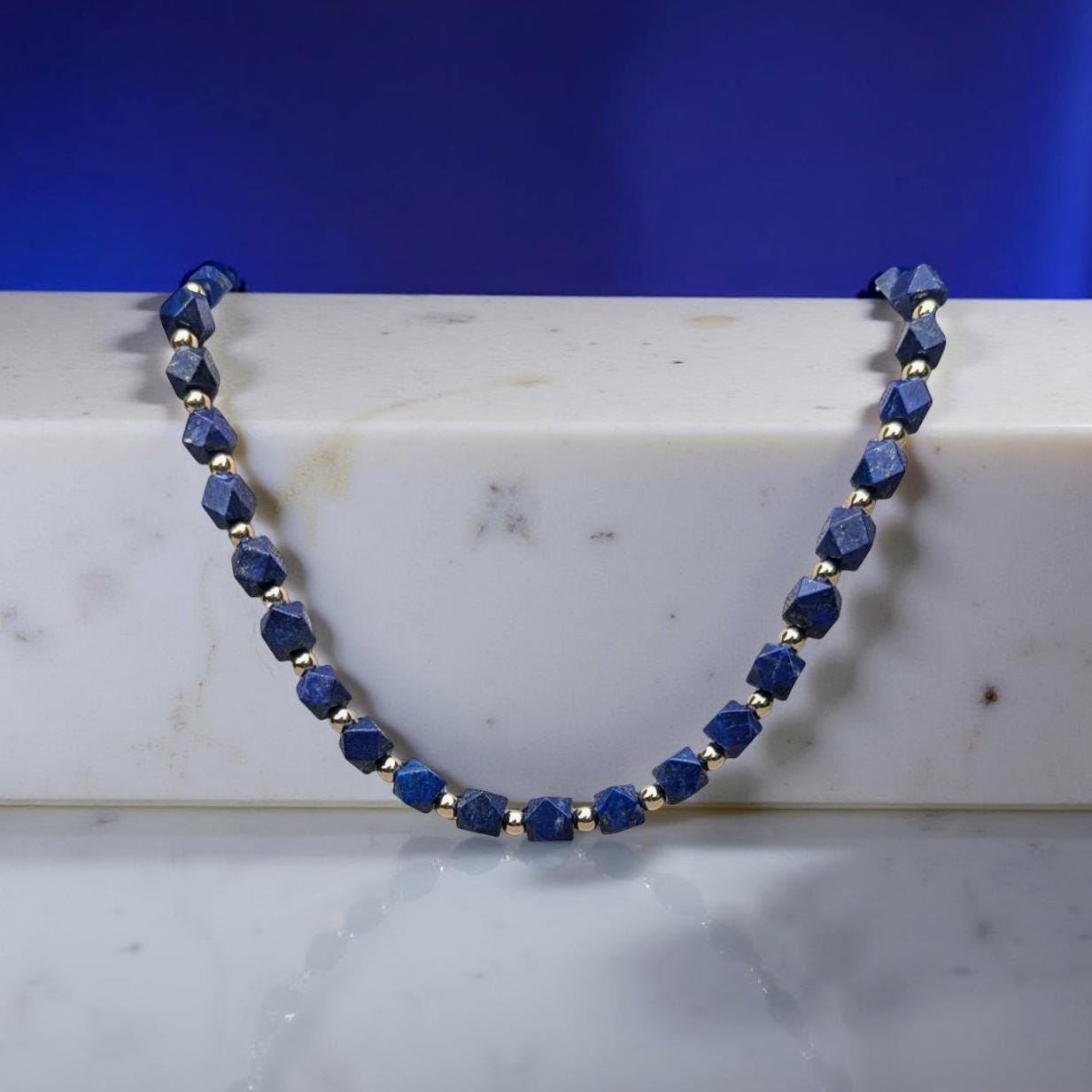 Lapis Lazuli Necklace. The square Lapis beads are faceted and interspersed with sparkling silver cubes. It's 21 inches in length.