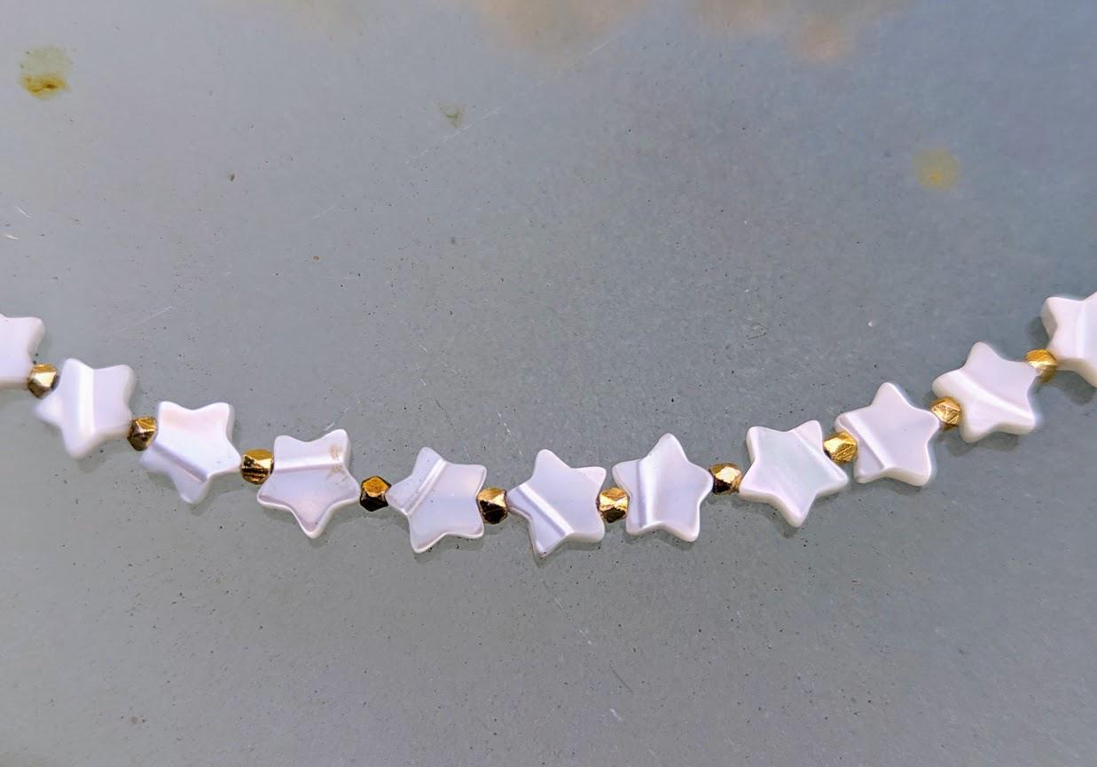 Mother-of-Pearl strand of stars. 18 inches in length. Great layering necklace