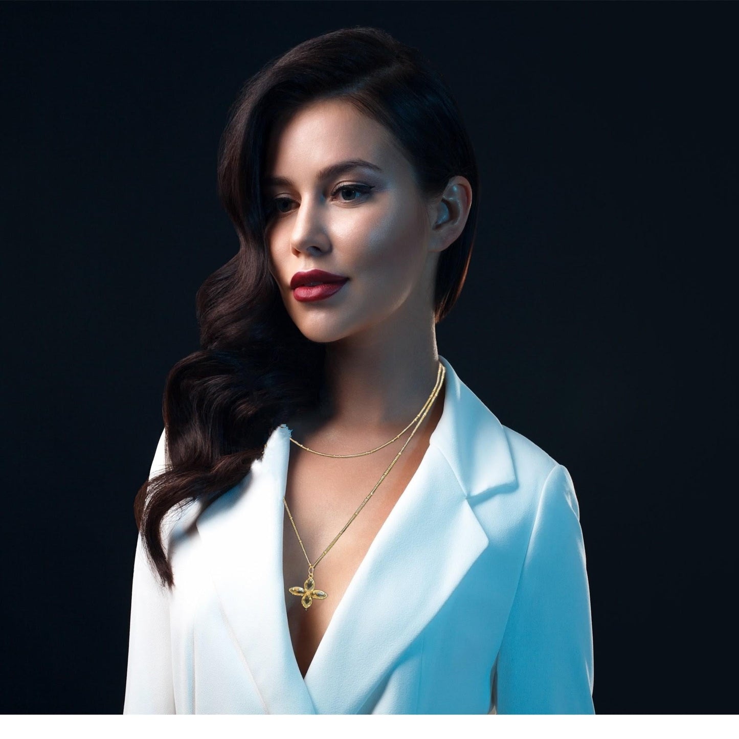 Delicate crystal pendant on a double chain. The crystal pendant is a translucent golden color.