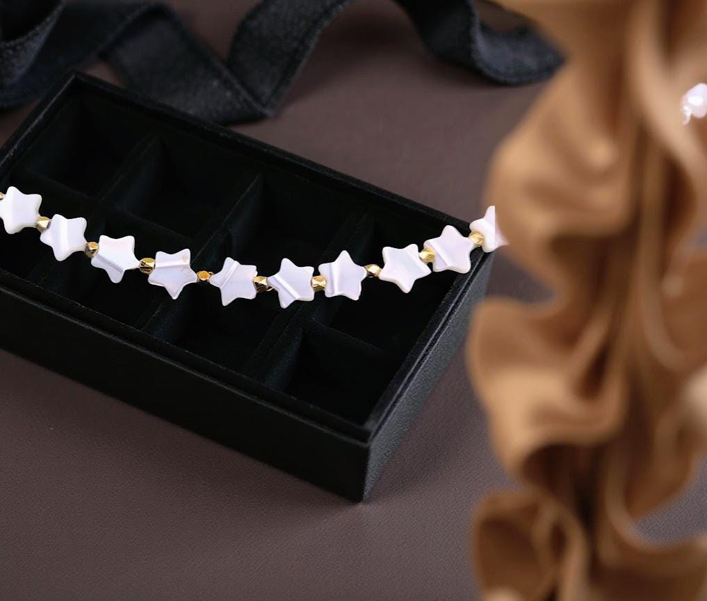 Mother-of-Pearl strand of stars. 18 inches in length. Great layering necklace