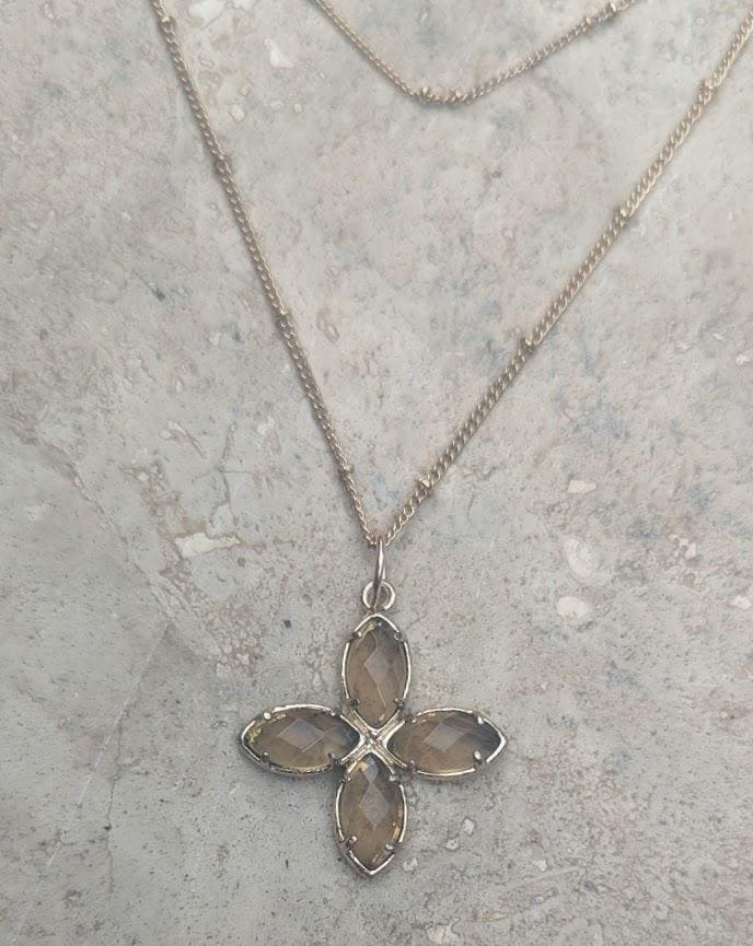 Delicate crystal pendant on a double chain. The crystal pendant is a translucent golden color.