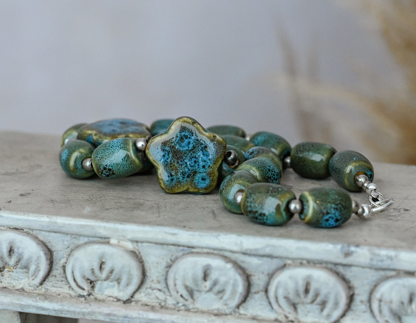 Artisan Ceramic Chunky Necklace. With shades of blue and tan, oval-shaped beads interspersed with star-shaped focals. Glossy with texture.