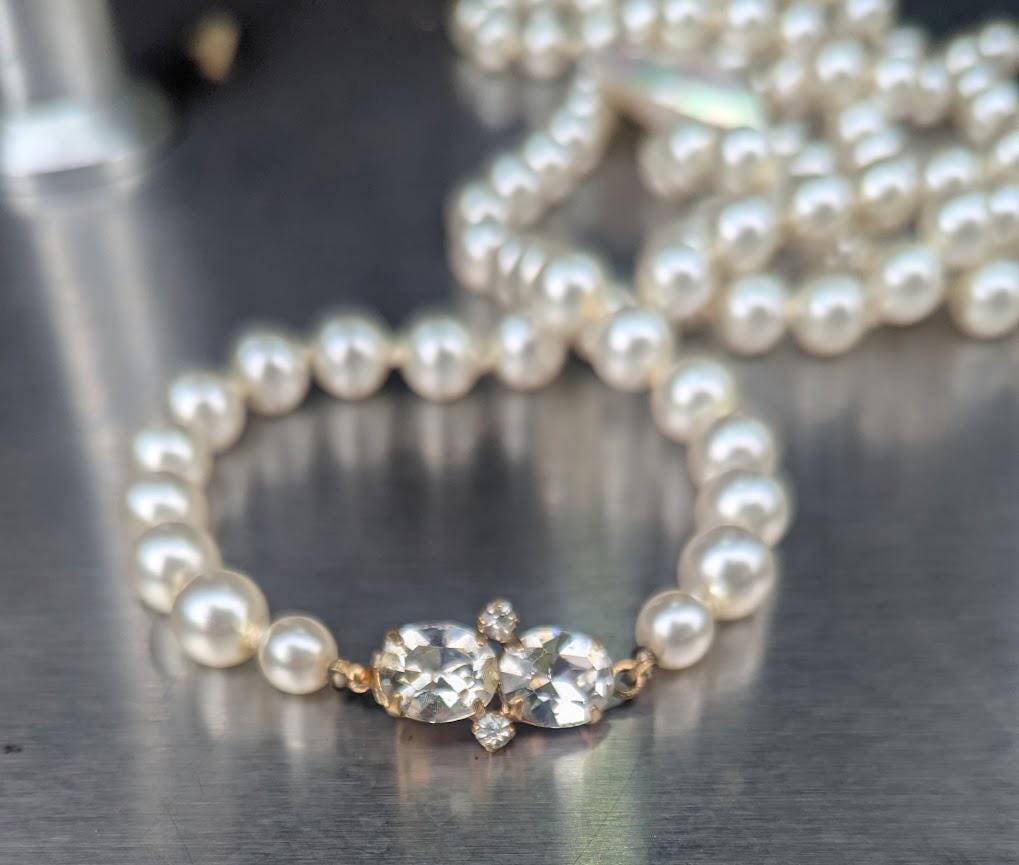 Pearl strand, bright white, 60 inches long, with a mother-of-pearl heart pendant, Decorative CZ closure. Can be wrapped one or two times