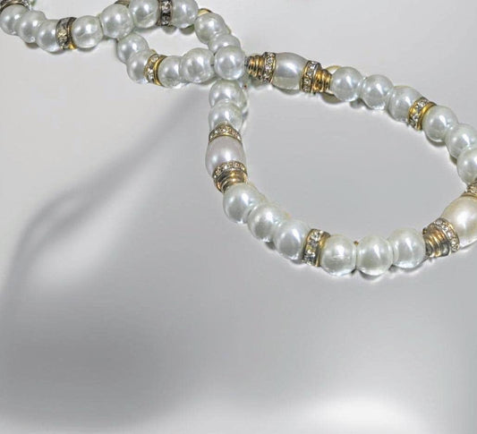 Elegant pearl necklace with vintage gold beads covered in sparkling rhinestones. 20 inches in length.