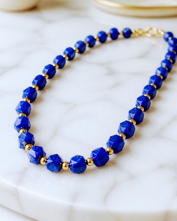 Faceted Lapis Cube Necklace with gold-tone accents. 21 inches in length
