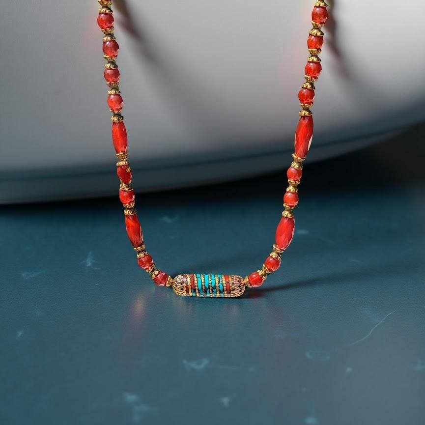 Carnelian necklace with Tibetan focal bead that is trimmed in turquoise.