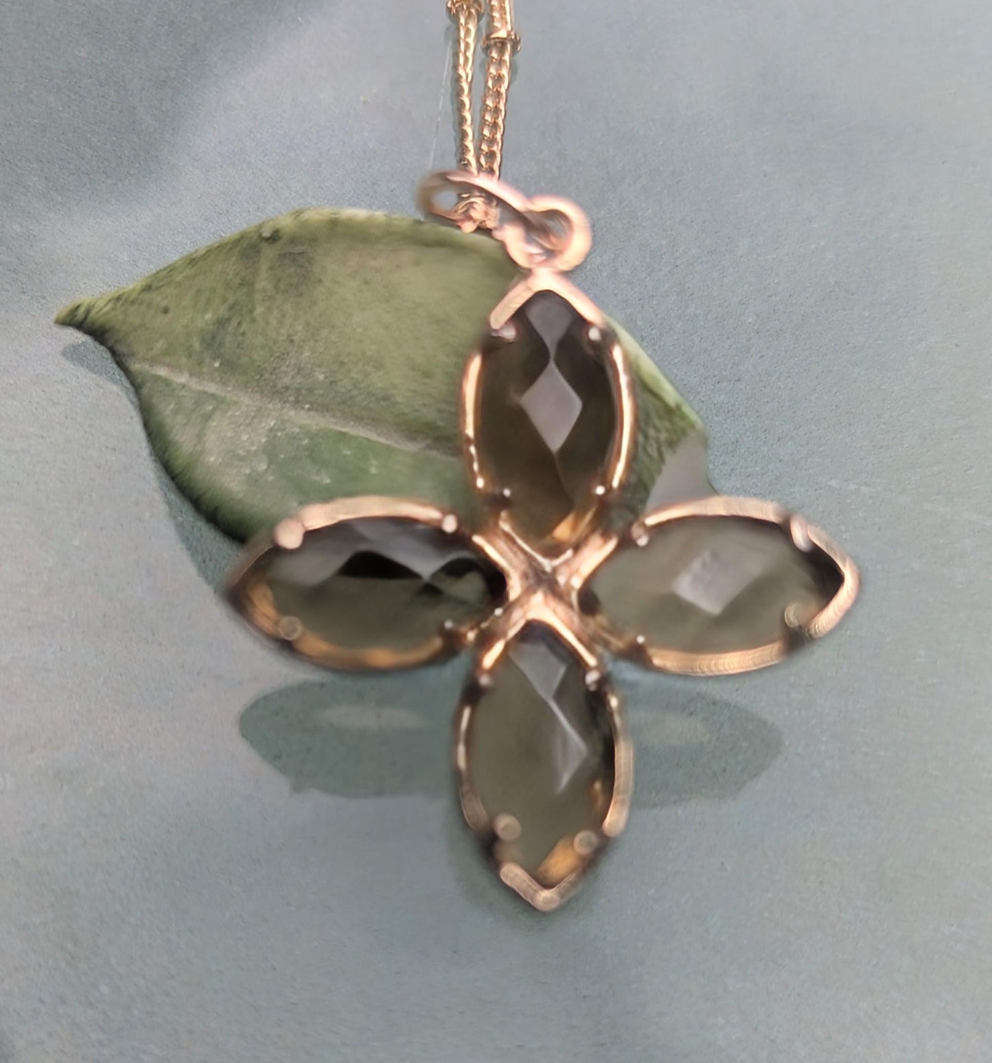 Delicate crystal pendant on a double chain. The crystal pendant is a translucent golden color.