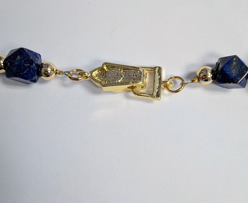 Faceted Lapis Cube Necklace with gold-tone accents. 21 inches in length
