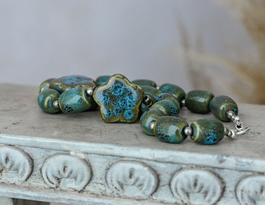 Artisan Ceramic Chunky Necklace. With shades of blue and tan, oval-shaped beads interspersed with star-shaped focals.  Glossy with texture.