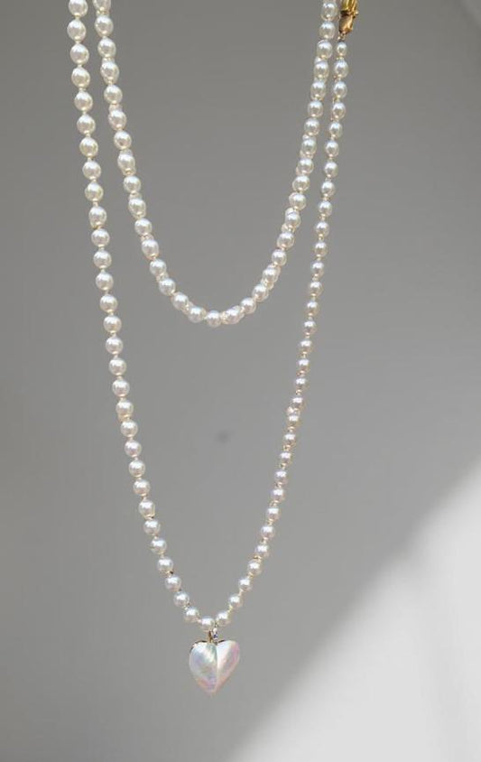 Pearl strand, bright white, 60 inches long, with a mother-of-pearl heart pendant, Decorative CZ closure. Can be wrapped one or two times