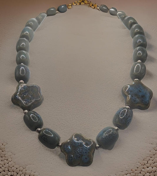 Artisan Ceramic Chunky Necklace. With shades of blue and tan, oval-shaped beads interspersed with star-shaped focals.  Glossy with texture.