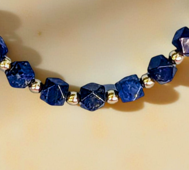 Faceted Lapis Cube Necklace with gold-tone accents. 21 inches in length