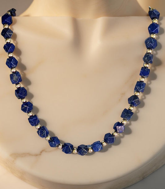 Faceted Lapis Cube Necklace with gold-tone accents. 21 inches in length